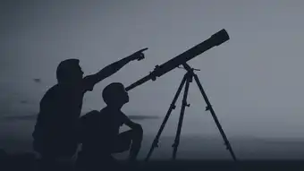 people looking into telescope